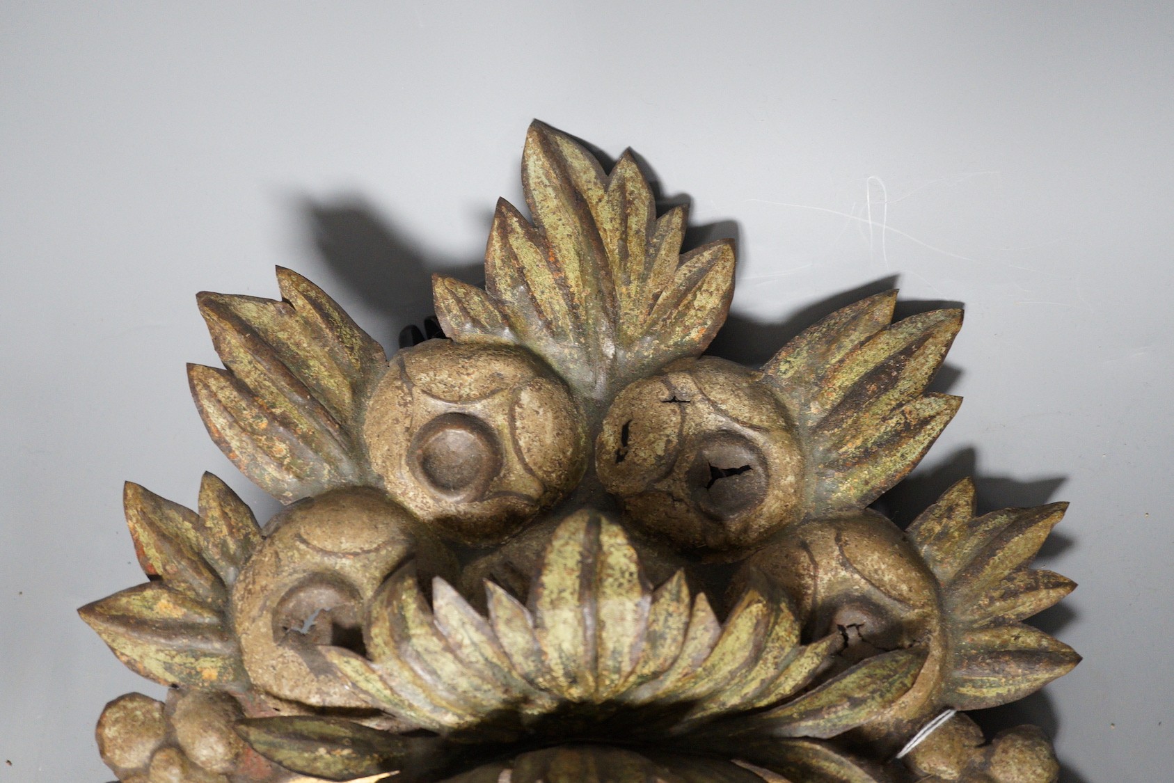 A painted embossed iron flower basket ornament